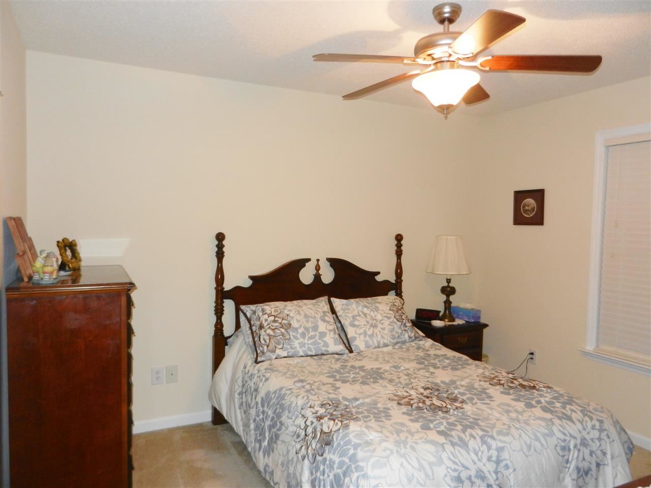 245 Saddle Ridge Drive Willow Spring, NC 27592 - Photo 22 of 24 a bedroom with a bed and a chandelier fan