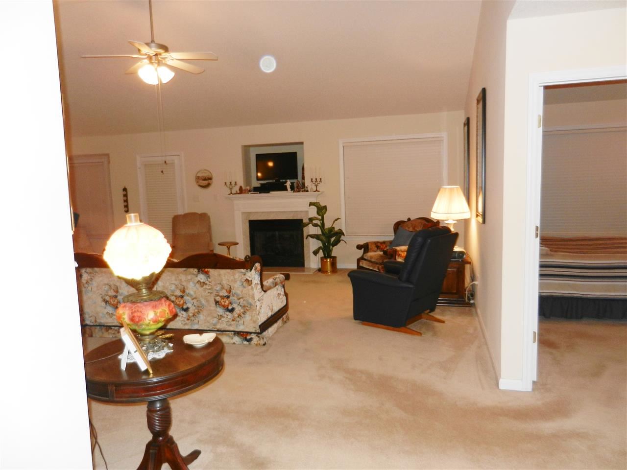245 Saddle Ridge Drive Willow Spring, NC 27592 - Photo 10 of 24 a living room with furniture a fireplace and a flat screen tv