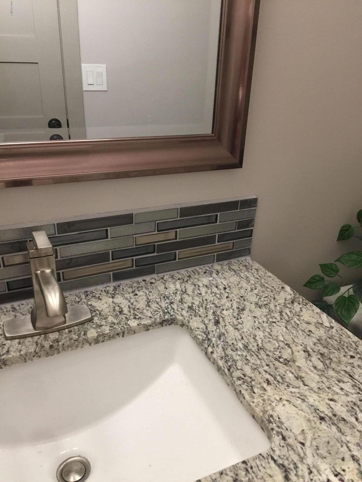 4221 North Miller Road Scottsdale, AZ 85251 - Photo 15 of 20 a bathroom with a bathtub and sink