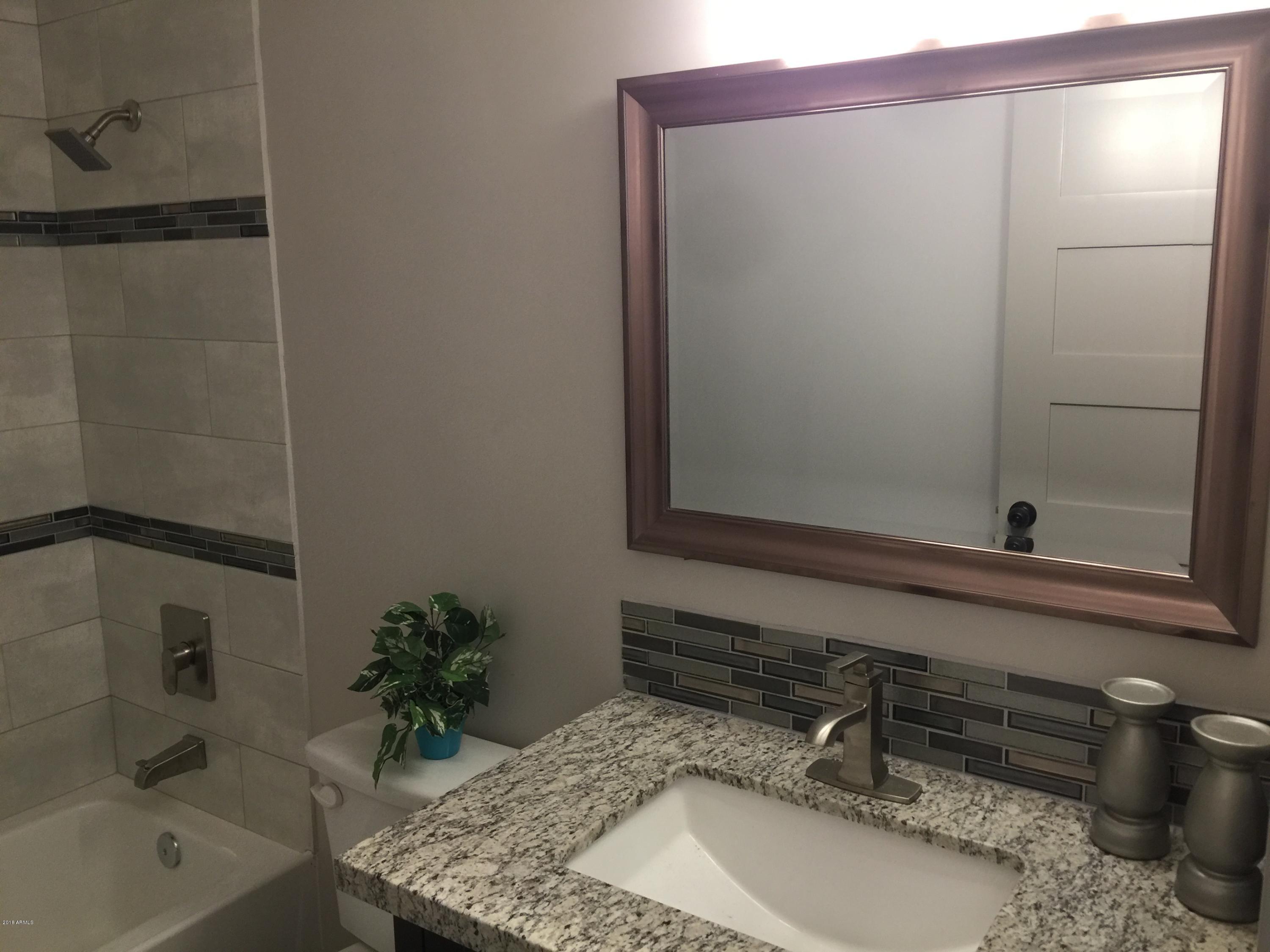 4221 North Miller Road Scottsdale, AZ 85251 - Photo 19 of 20 a bathroom with a sink and a mirror