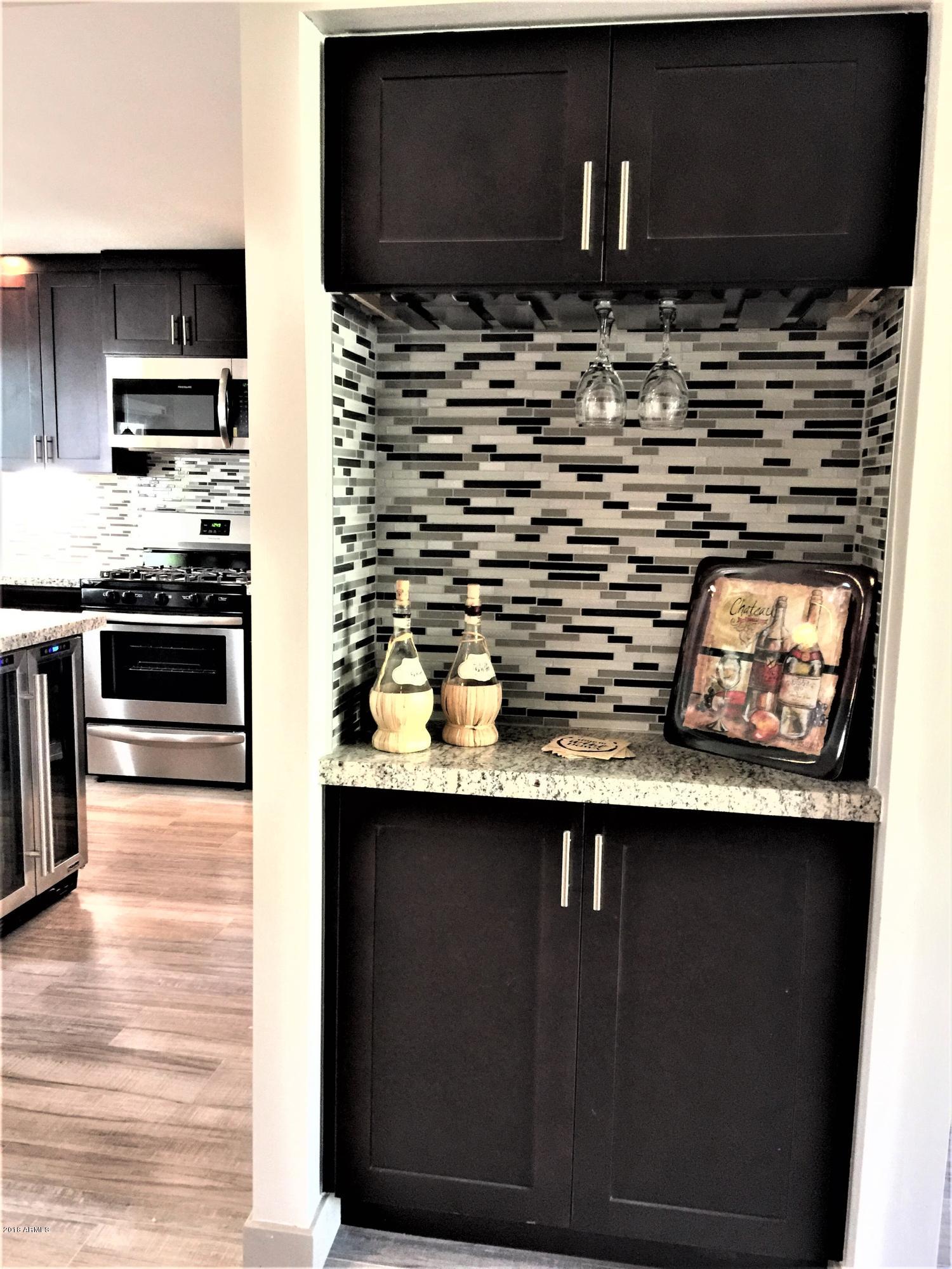 4221 North Miller Road Scottsdale, AZ 85251 - Photo 4 of 20 a kitchen with stainless steel appliances a sink stove and microwave