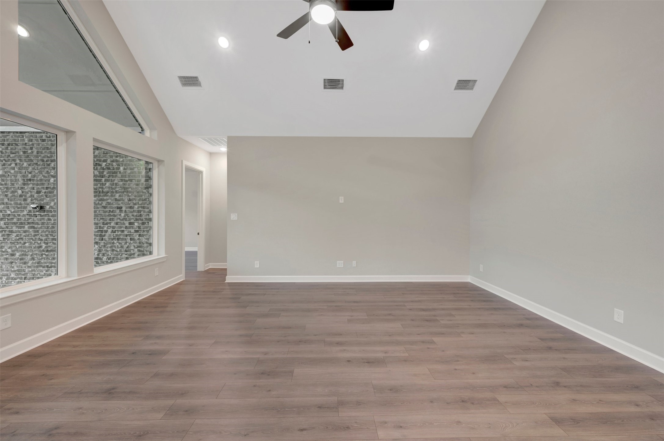 15722 Terracotta Terrace Conroe, TX 77302 - Photo 39 of 50 an empty room with wooden floor fan and windows