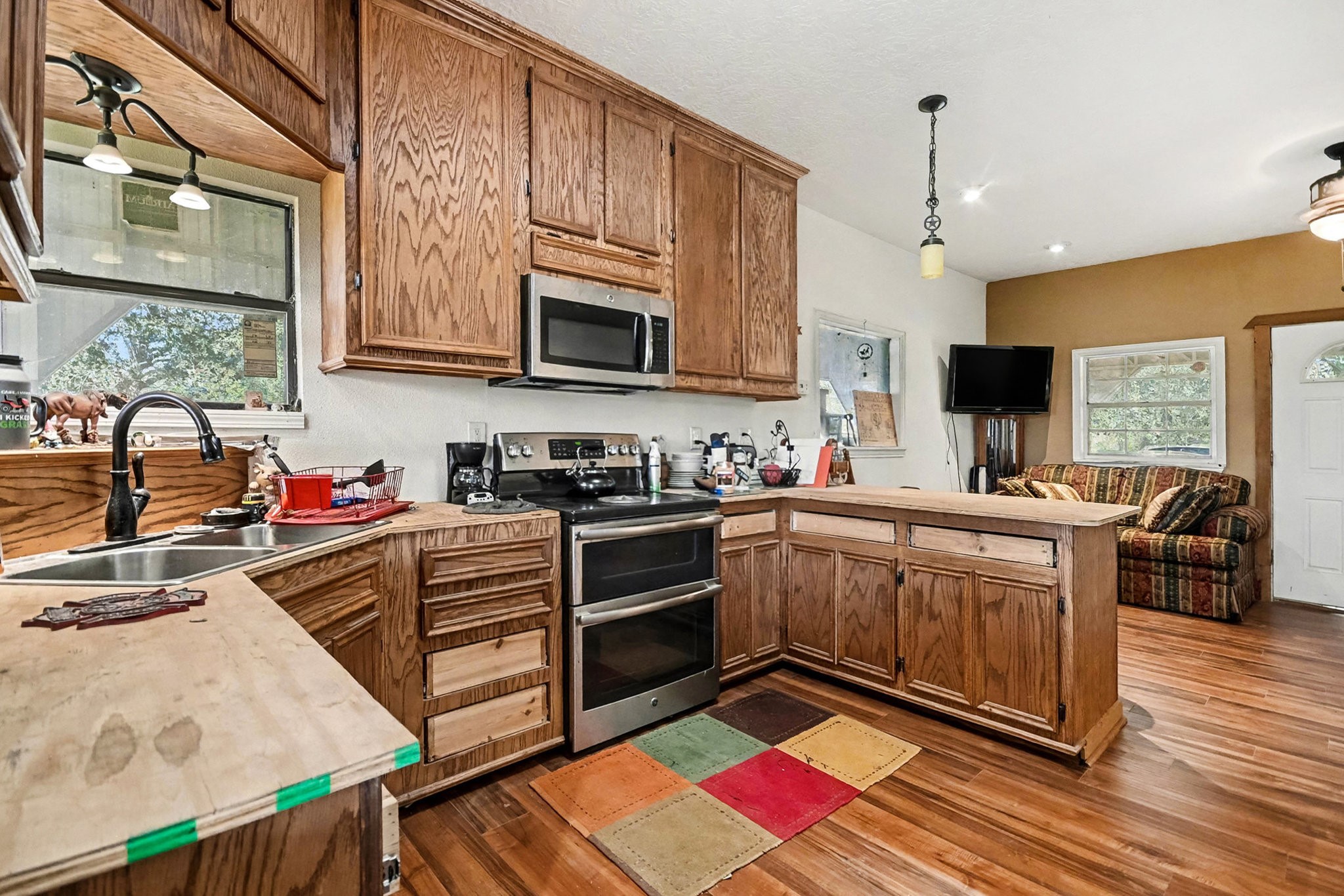 18303 Ramsey Road Crosby, TX 77532 - Photo 21 of 24 a kitchen with stainless steel appliances kitchen island granite countertop a sink stove and cabinets