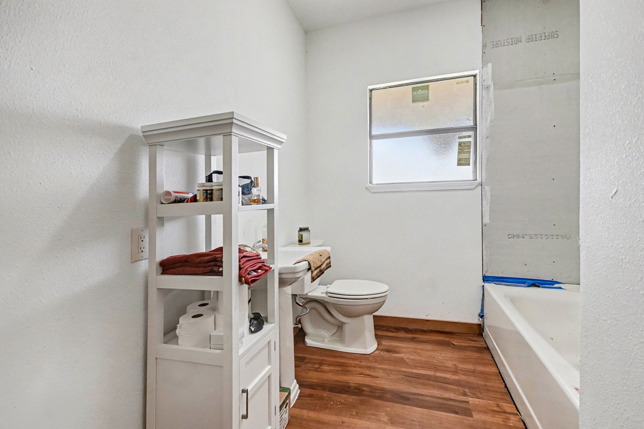 18303 Ramsey Road Crosby, TX 77532 - Photo 24 of 24 a white toilet sitting next to a bathroom sink and vanity
