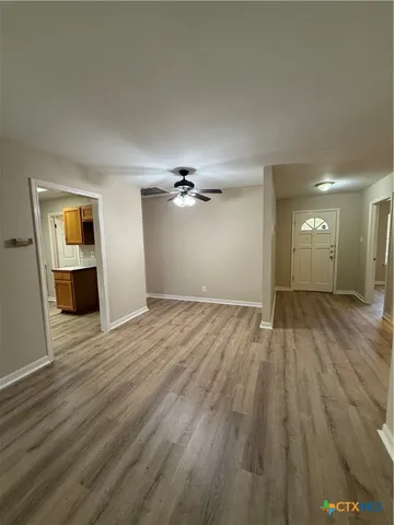 a large kitchen with stainless steel appliances wooden cabinets and a counter top space