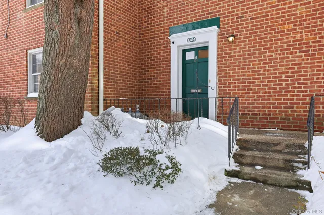 a view of a lounge chair in front of brick house