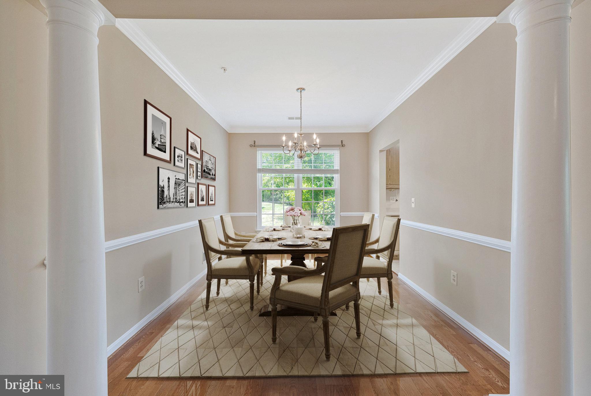 8600 Roaming Ridge Way, Unit 106 Odenton, MD 21113 - Photo 12 of 52 a dining room with furniture a rug and wooden floor