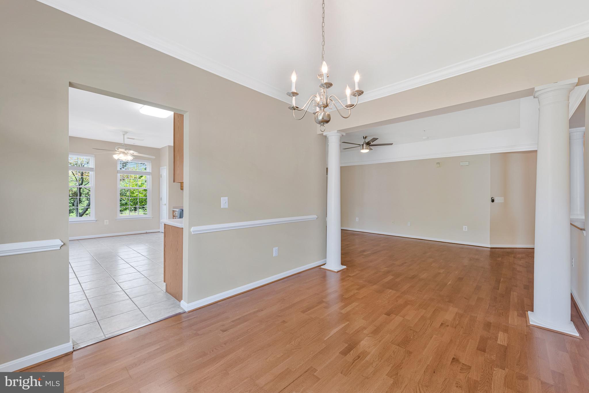 8600 Roaming Ridge Way, Unit 106 Odenton, MD 21113 - Photo 13 of 52 wooden floor in an empty room with a window