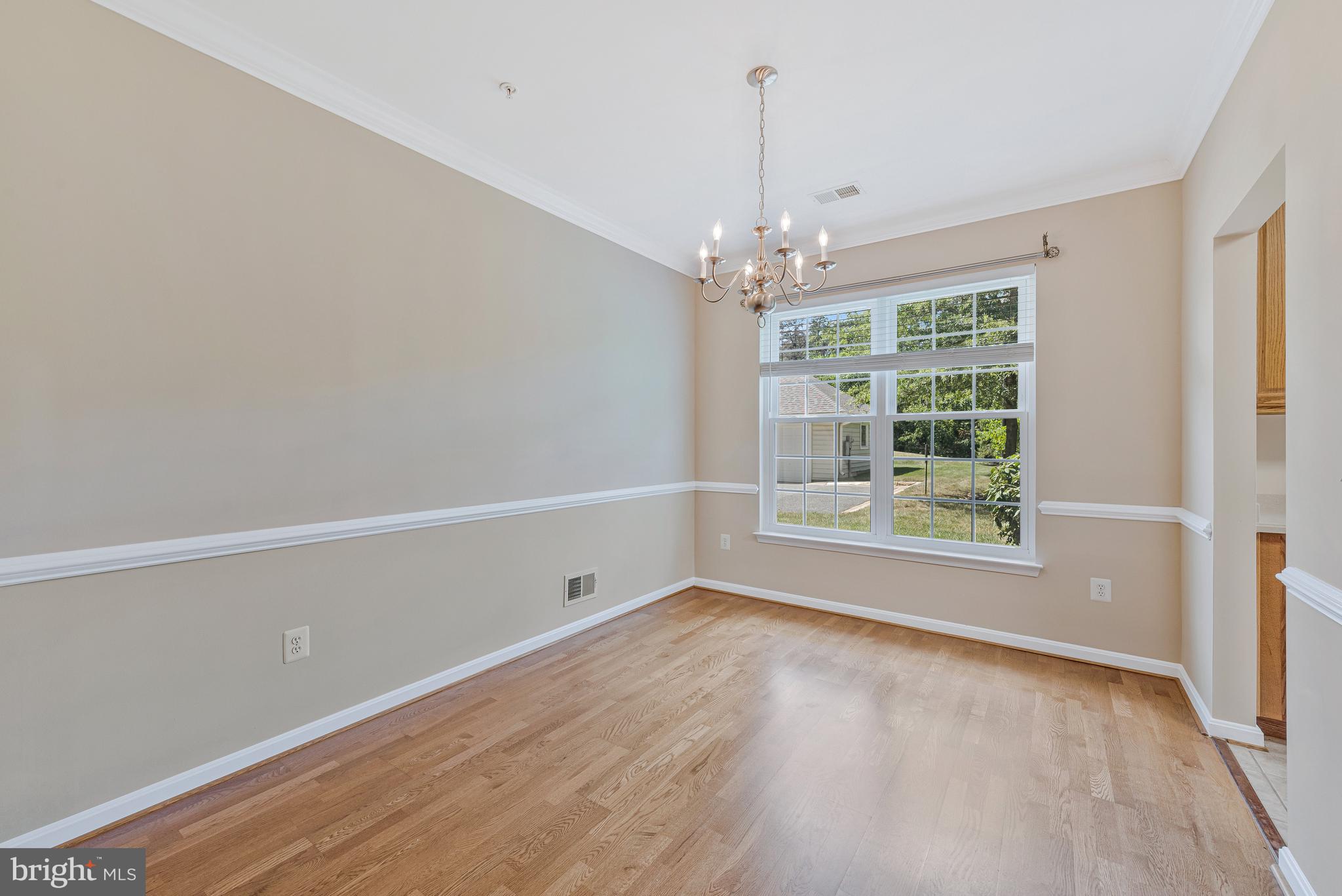 8600 Roaming Ridge Way, Unit 106 Odenton, MD 21113 - Photo 14 of 52 wooden floor in an empty room with a window
