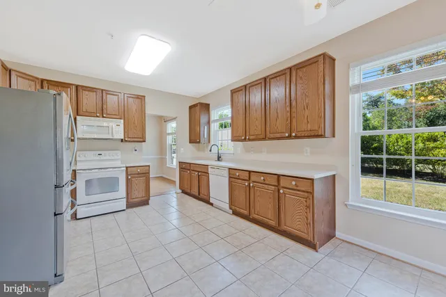 a kitchen with stainless steel appliances a refrigerator sink and cabinets