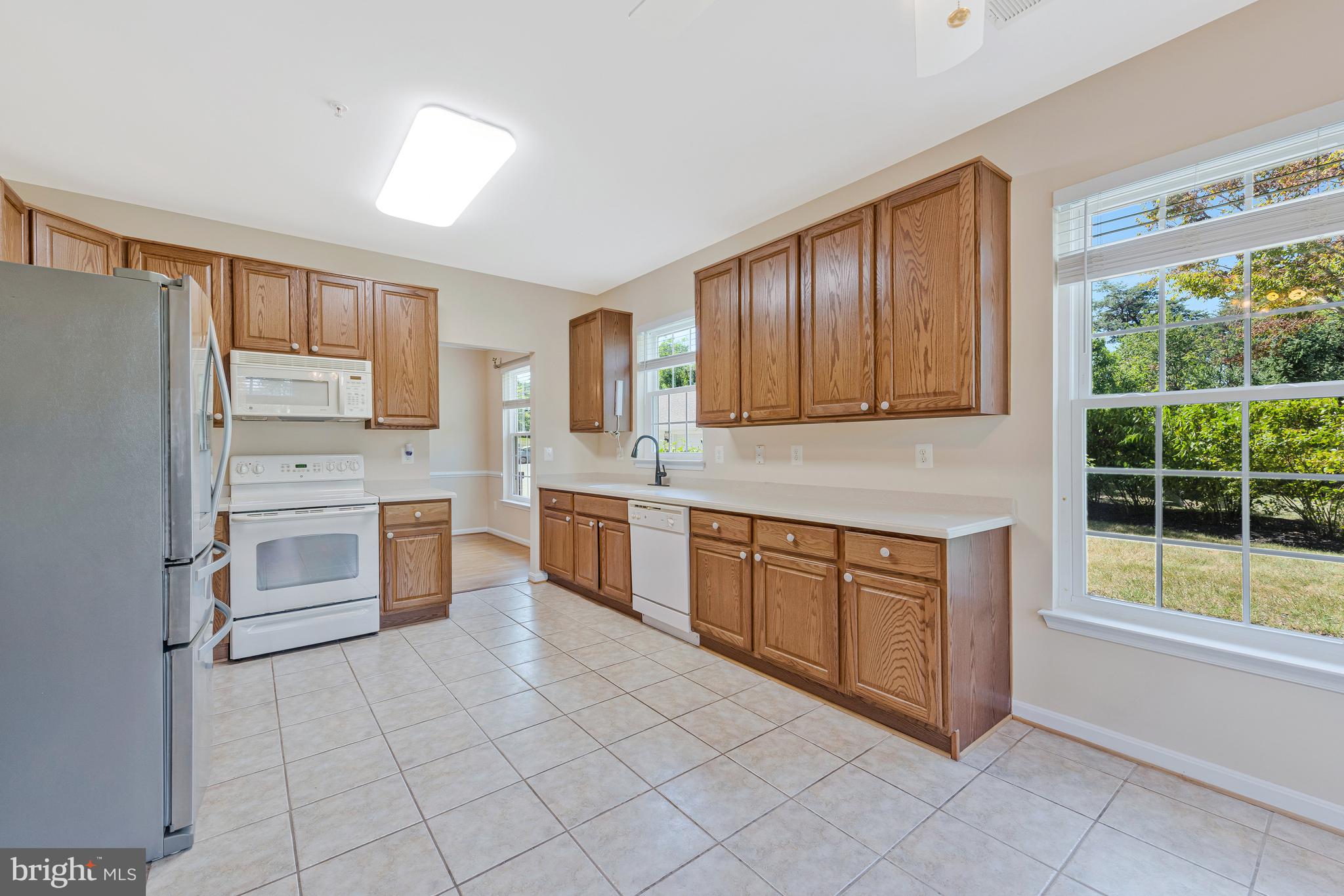 8600 Roaming Ridge Way, Unit 106 Odenton, MD 21113 - Photo 15 of 52 a kitchen with stainless steel appliances a stove sink and cabinets