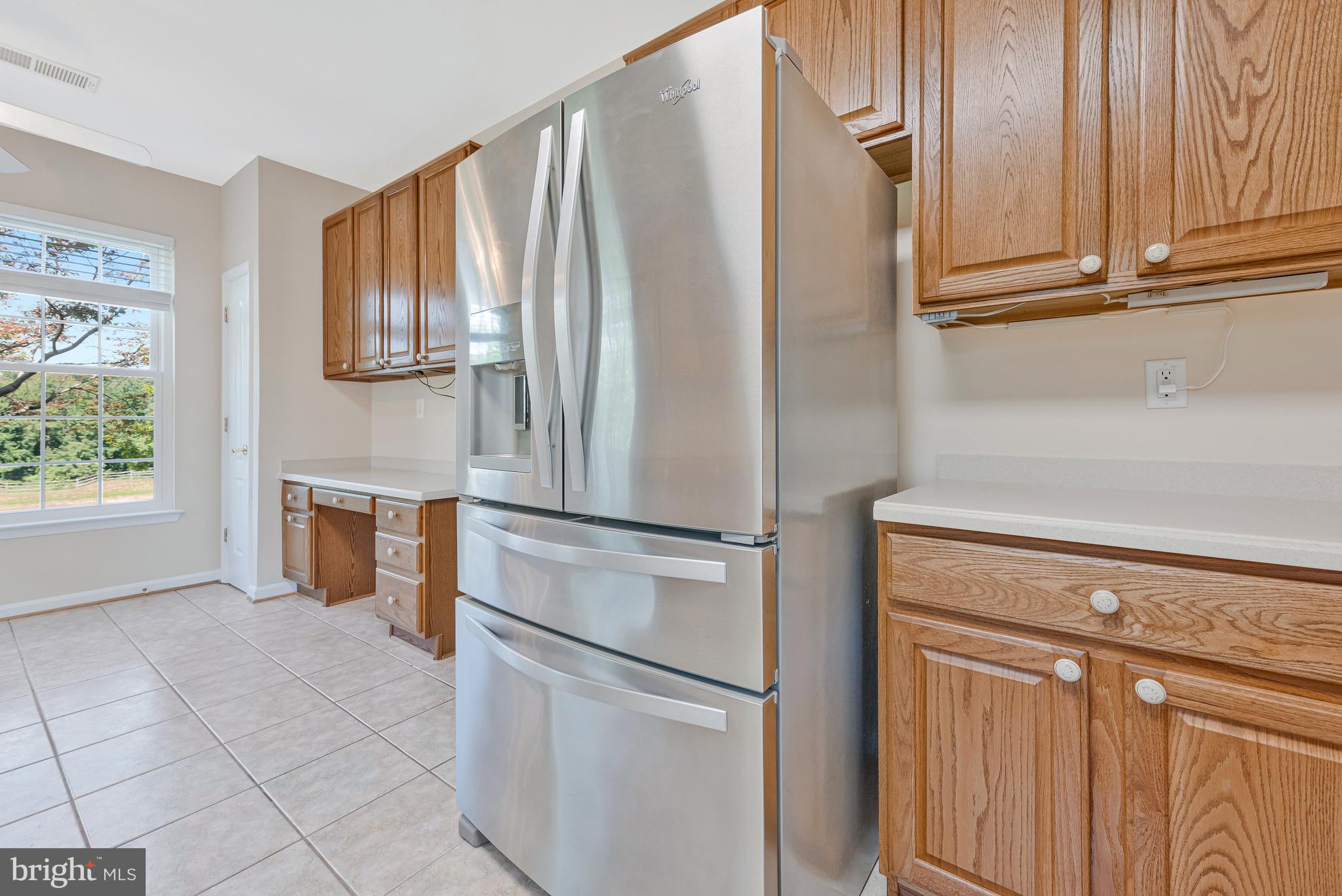 8600 Roaming Ridge Way, Unit 106 Odenton, MD 21113 - Photo 19 of 52 a kitchen with stainless steel appliances a refrigerator and a stove top oven