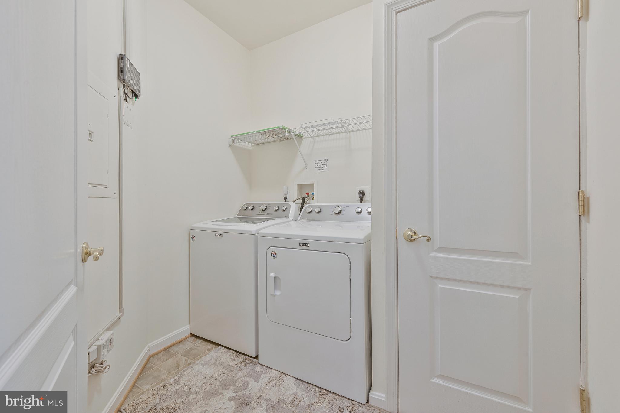 8600 Roaming Ridge Way, Unit 106 Odenton, MD 21113 - Photo 21 of 52 a utility room with cabinets washer and dryer