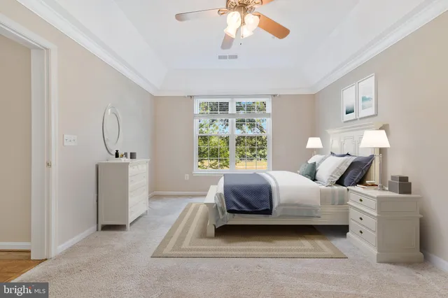 an empty room with ceiling fan and window