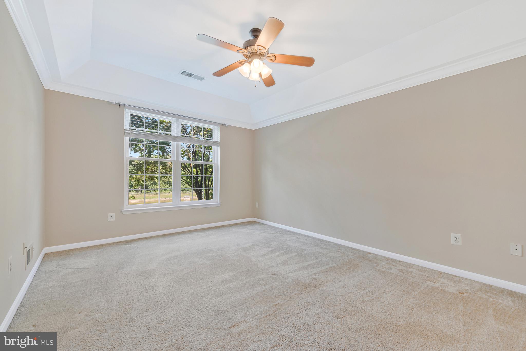 8600 Roaming Ridge Way, Unit 106 Odenton, MD 21113 - Photo 28 of 52 an empty room with ceiling fan and window