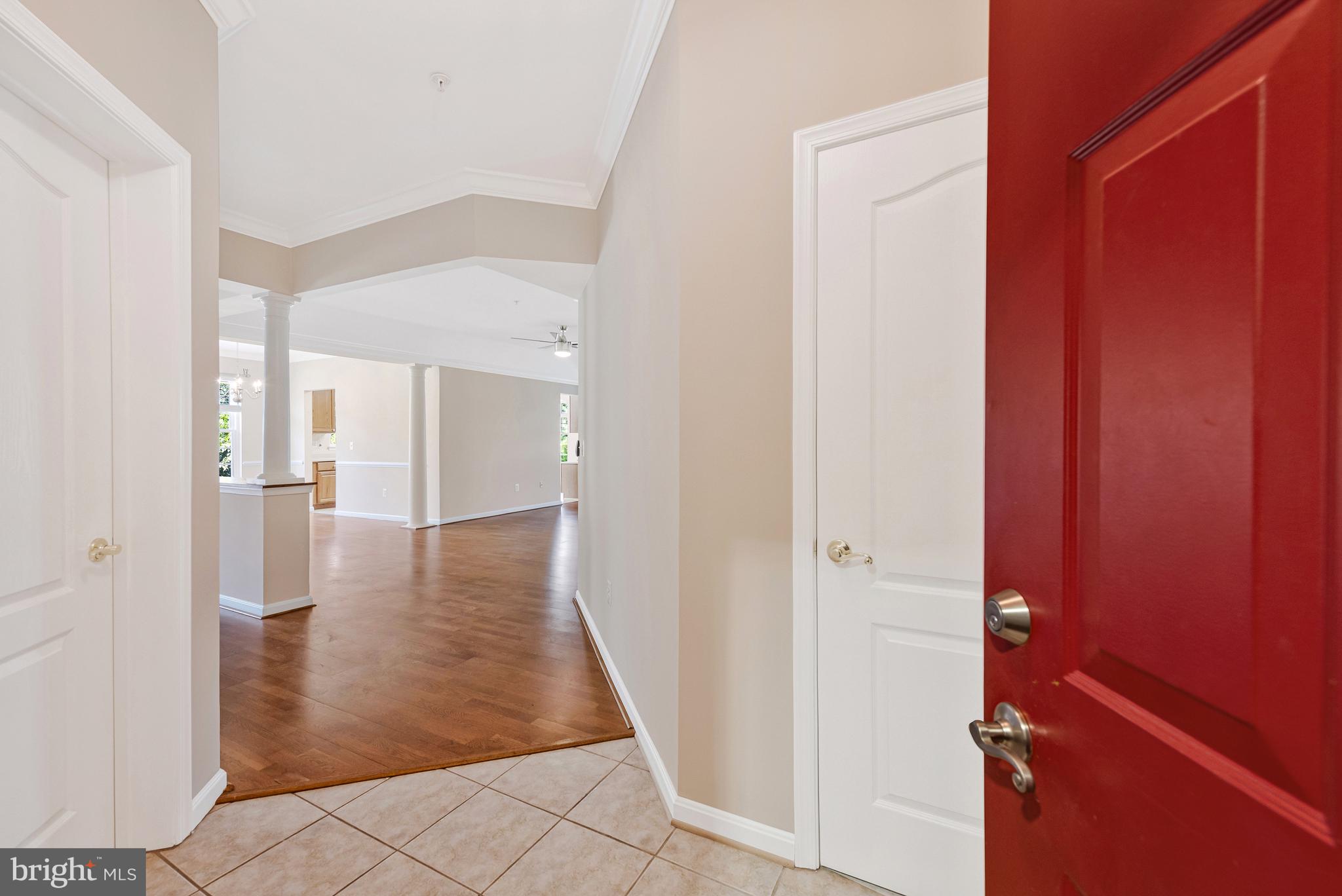 8600 Roaming Ridge Way, Unit 106 Odenton, MD 21113 - Photo 3 of 52 a view of a hallway with wooden floor