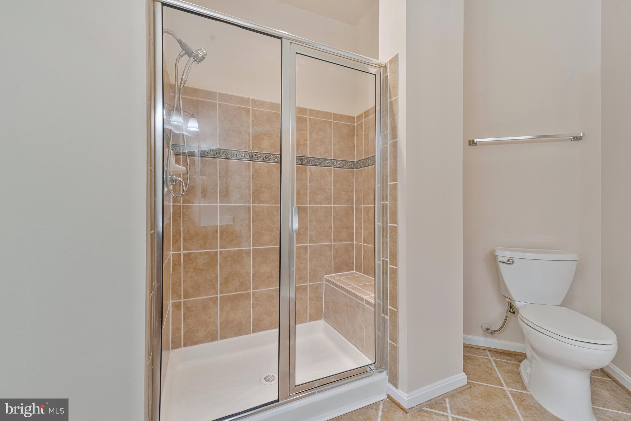 8600 Roaming Ridge Way, Unit 106 Odenton, MD 21113 - Photo 32 of 52 a bathroom with a shower and toilet