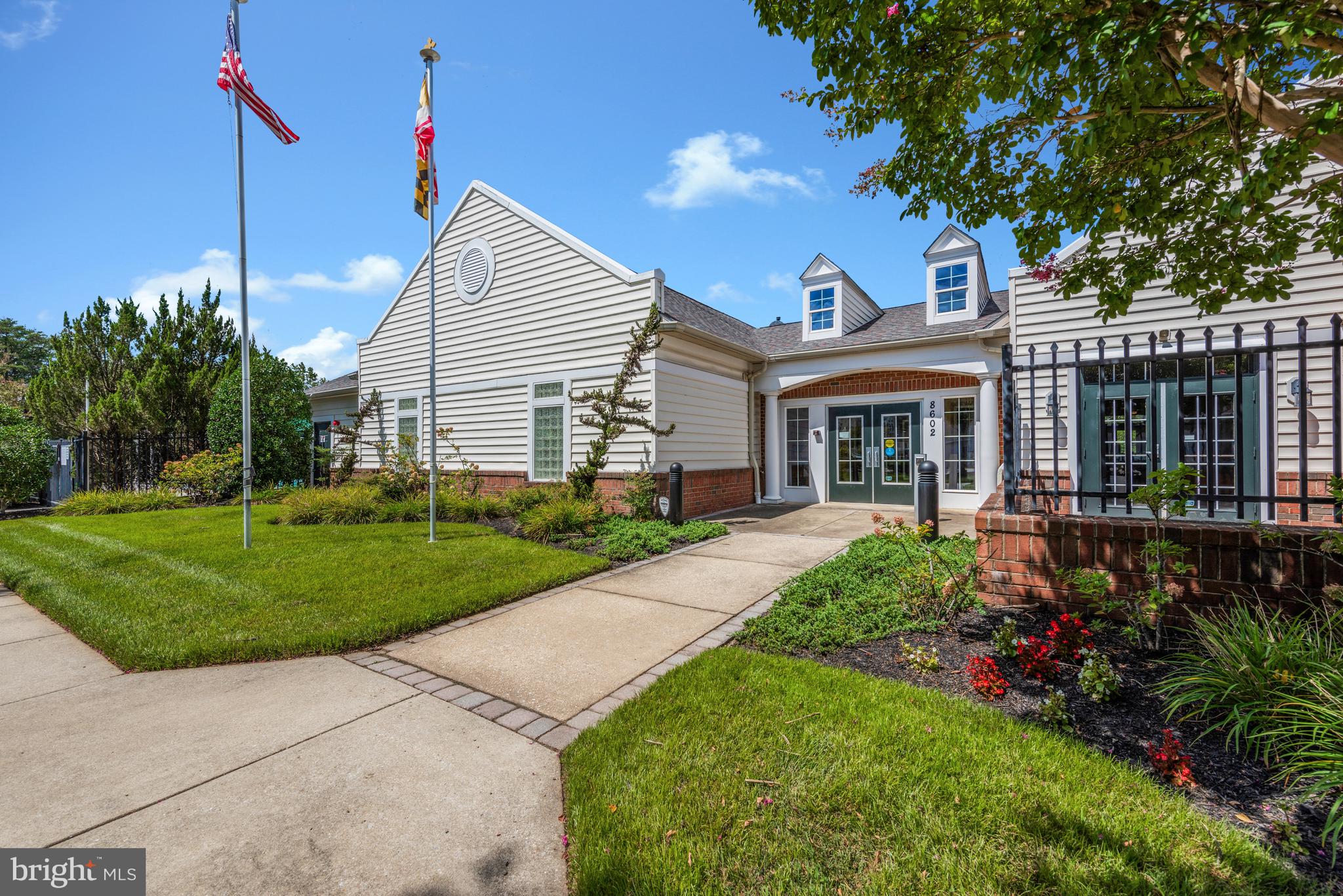 8600 Roaming Ridge Way, Unit 106 Odenton, MD 21113 - Photo 41 of 52 a view of a house with a yard and potted plants