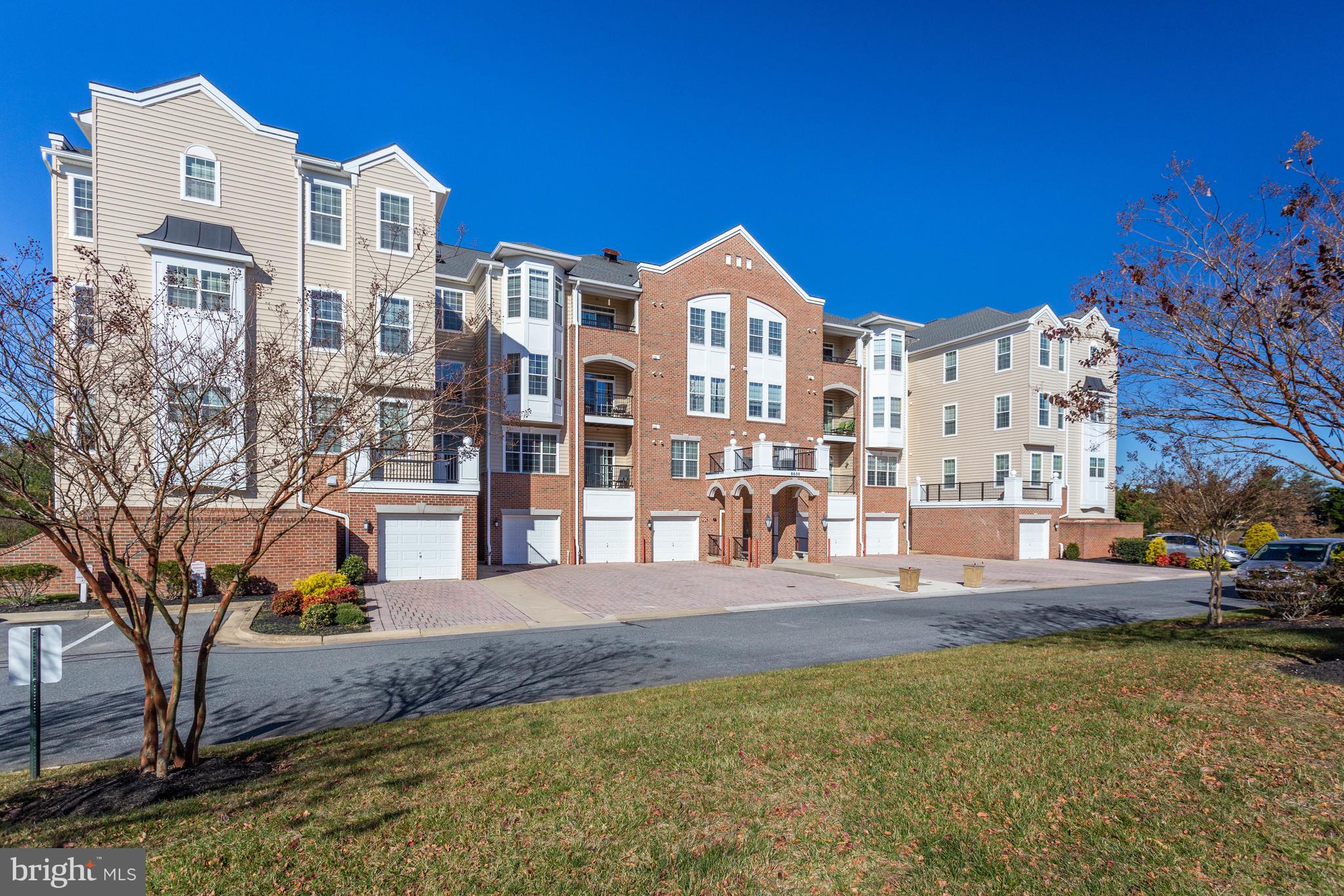 8600 Roaming Ridge Way, Unit 106 Odenton, MD 21113 - Photo 43 of 52 a view of multiple houses with a yard