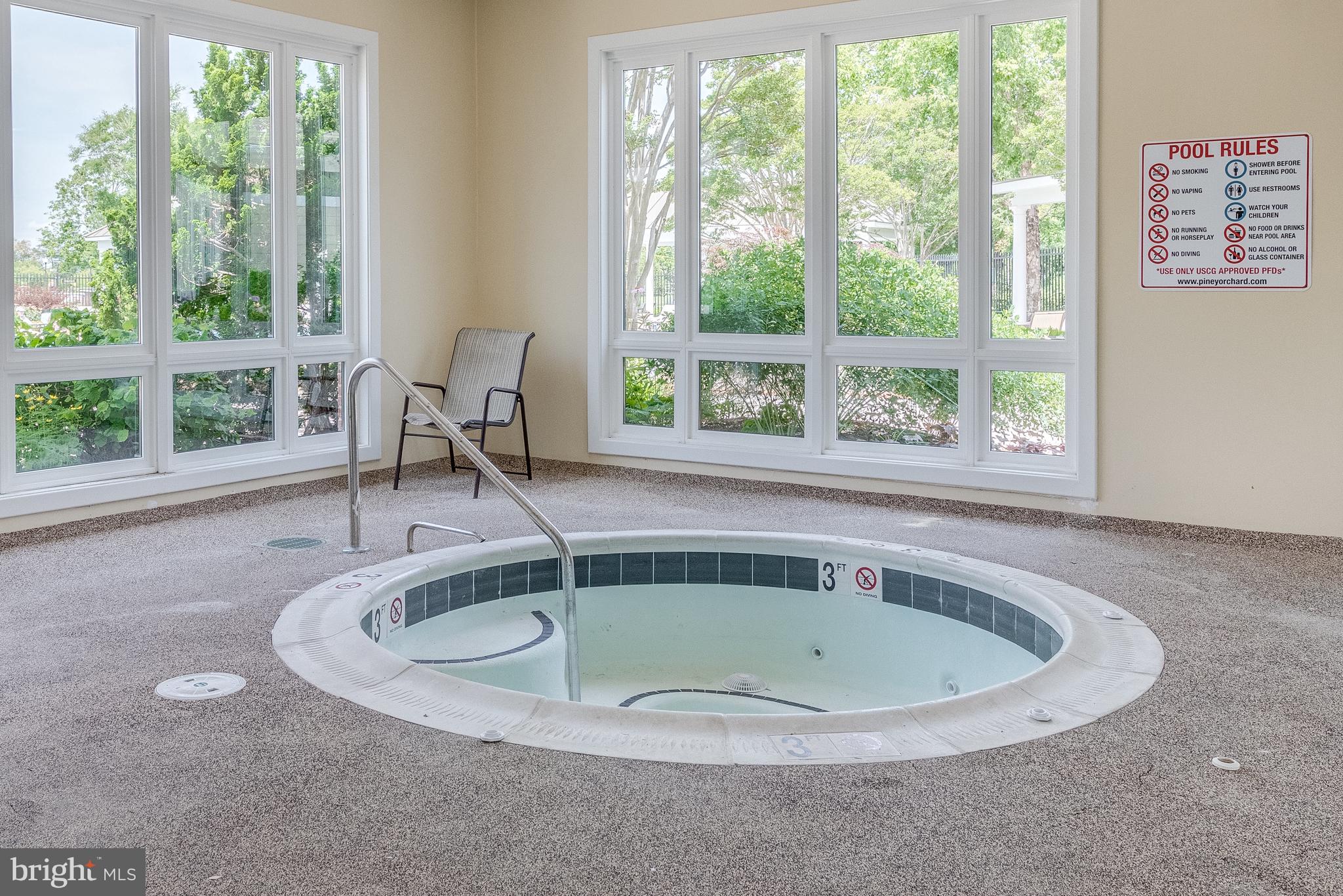 8600 Roaming Ridge Way, Unit 106 Odenton, MD 21113 - Photo 48 of 52 a bath tub sitting in a bathroom next to a window