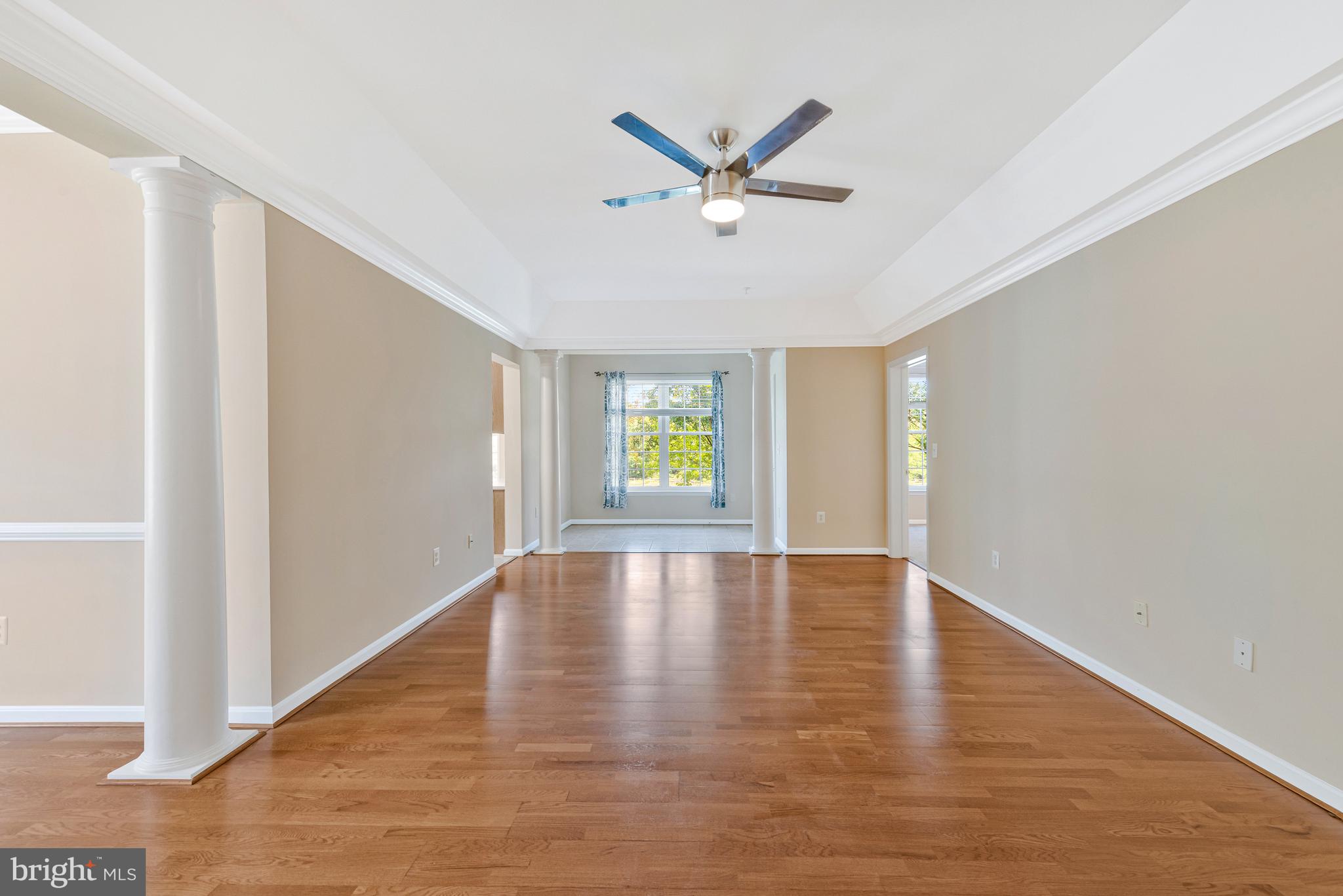 8600 Roaming Ridge Way, Unit 106 Odenton, MD 21113 - Photo 8 of 52 a view of empty room with wooden floor and ceiling fan