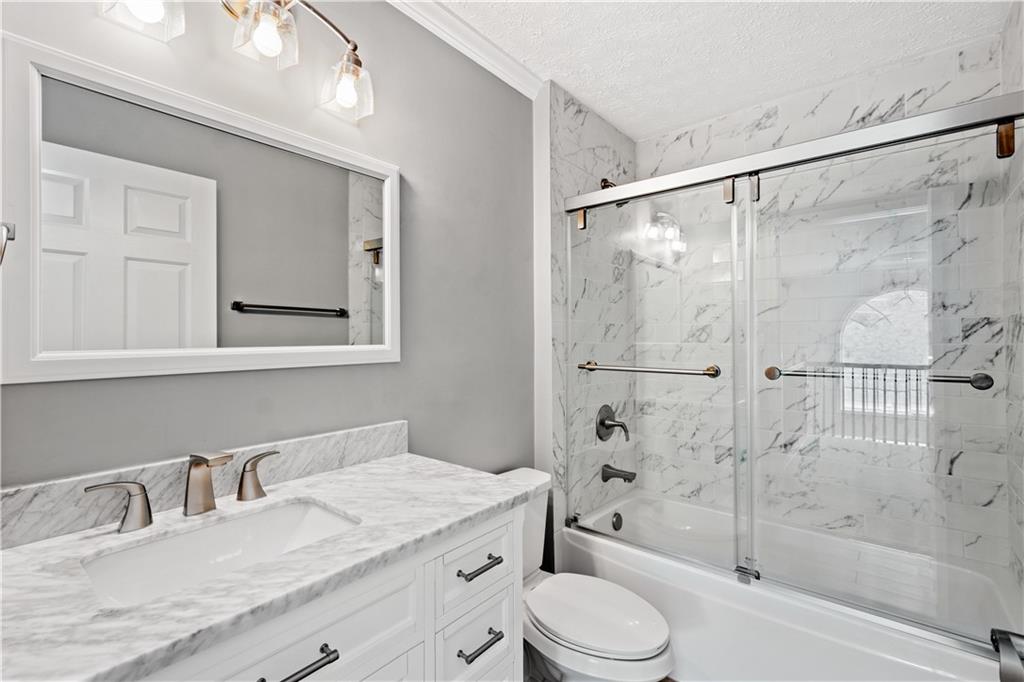 543 Hickory Grade Road Bridgeville, PA 15017 - Photo 24 of 32 a bathroom with a granite countertop sink toilet and shower