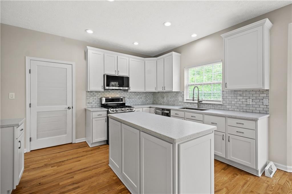 543 Hickory Grade Road Bridgeville, PA 15017 - Photo 5 of 32 a kitchen with a stove a sink and a microwave