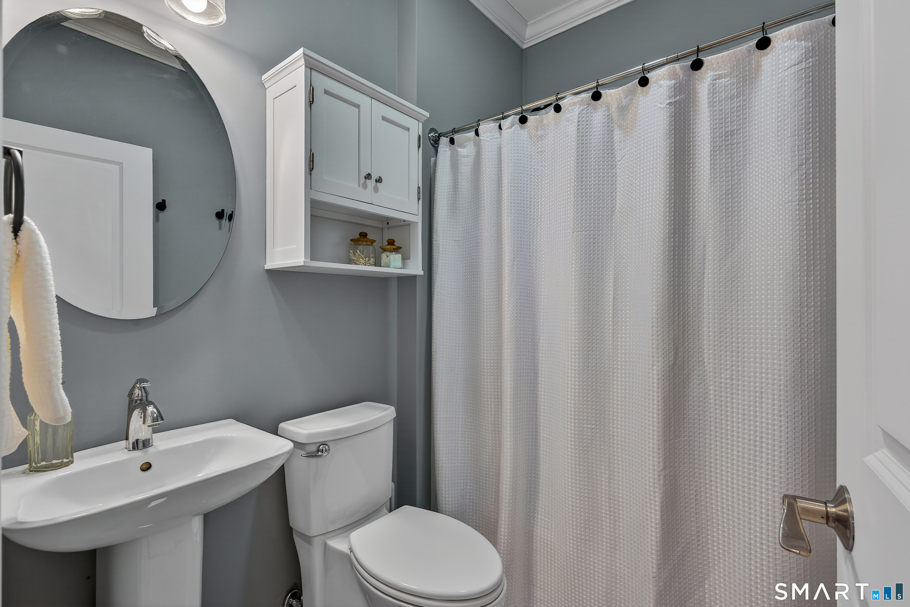 91 Hampden Road Stafford, CT 06076 - Photo 17 of 40 a bathroom with a sink a toilet and shower curtain