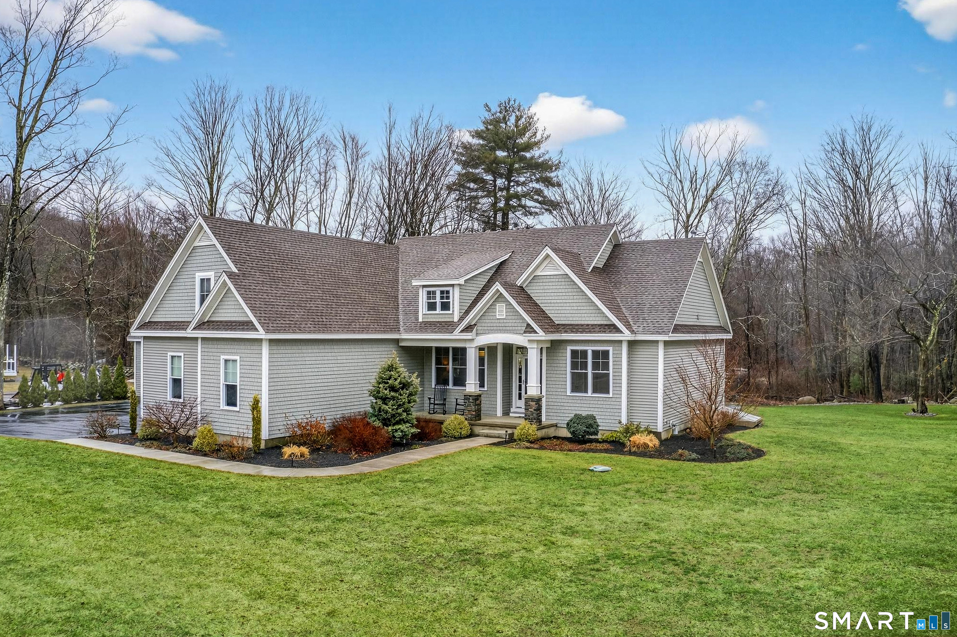 91 Hampden Road Stafford, CT 06076 - Photo 2 of 40 a view of a big house with a big yard potted plants and large tree