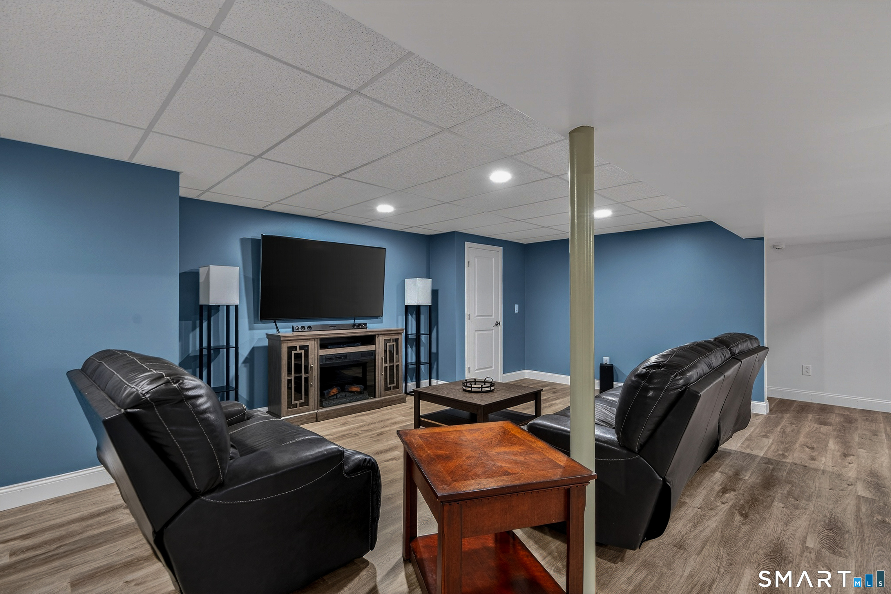 91 Hampden Road Stafford, CT 06076 - Photo 29 of 40 a living room with furniture and a flat screen tv