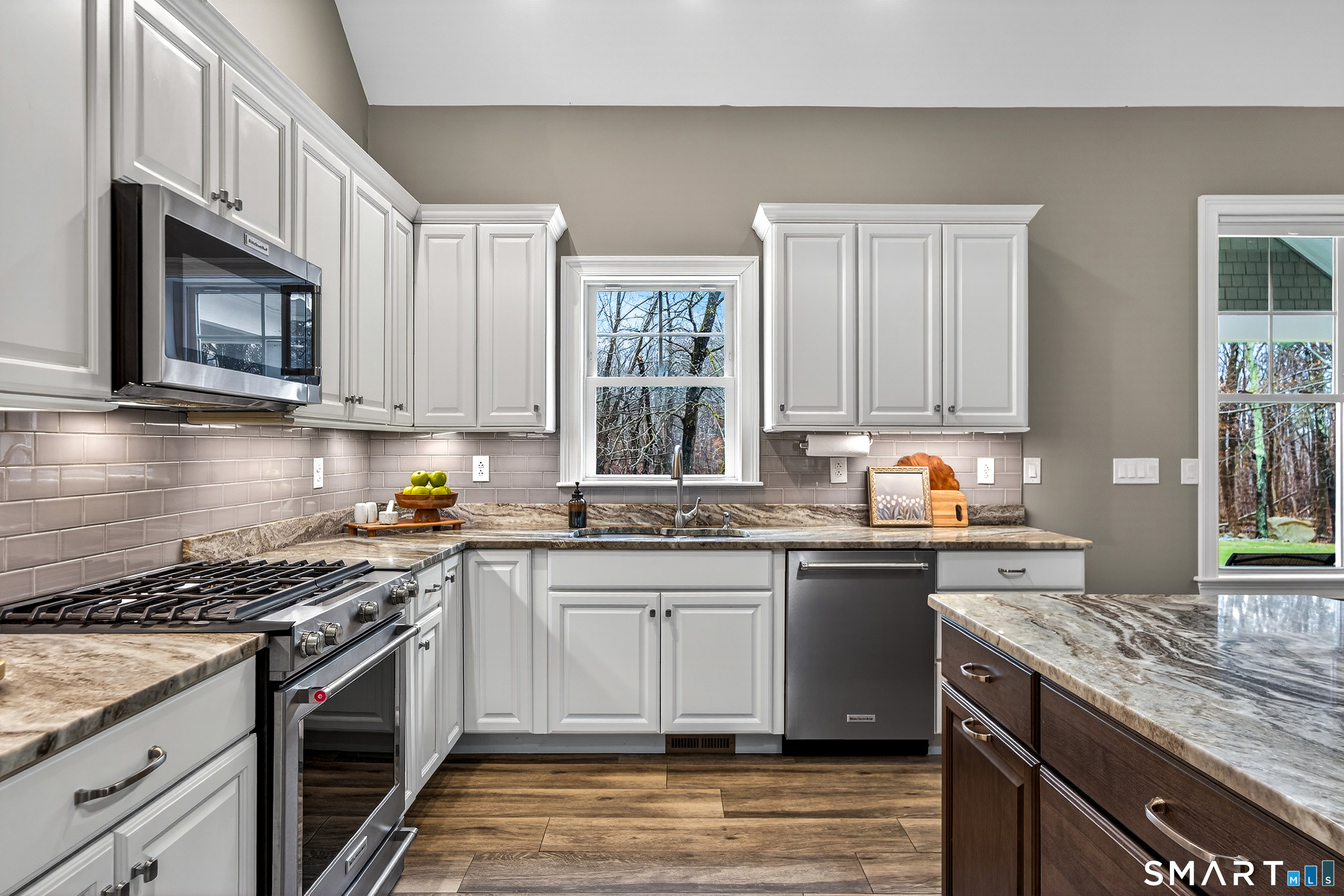 91 Hampden Road Stafford, CT 06076 - Photo 7 of 40 a kitchen with stainless steel appliances granite countertop a stove top oven a sink dishwasher and cabinets with wooden floor
