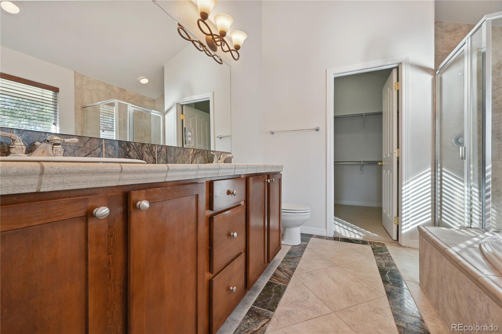 3515 Perry Street Denver, CO 80212 - Photo 17 of 40 a spacious bathroom with a sink a mirror a bathtub and shower