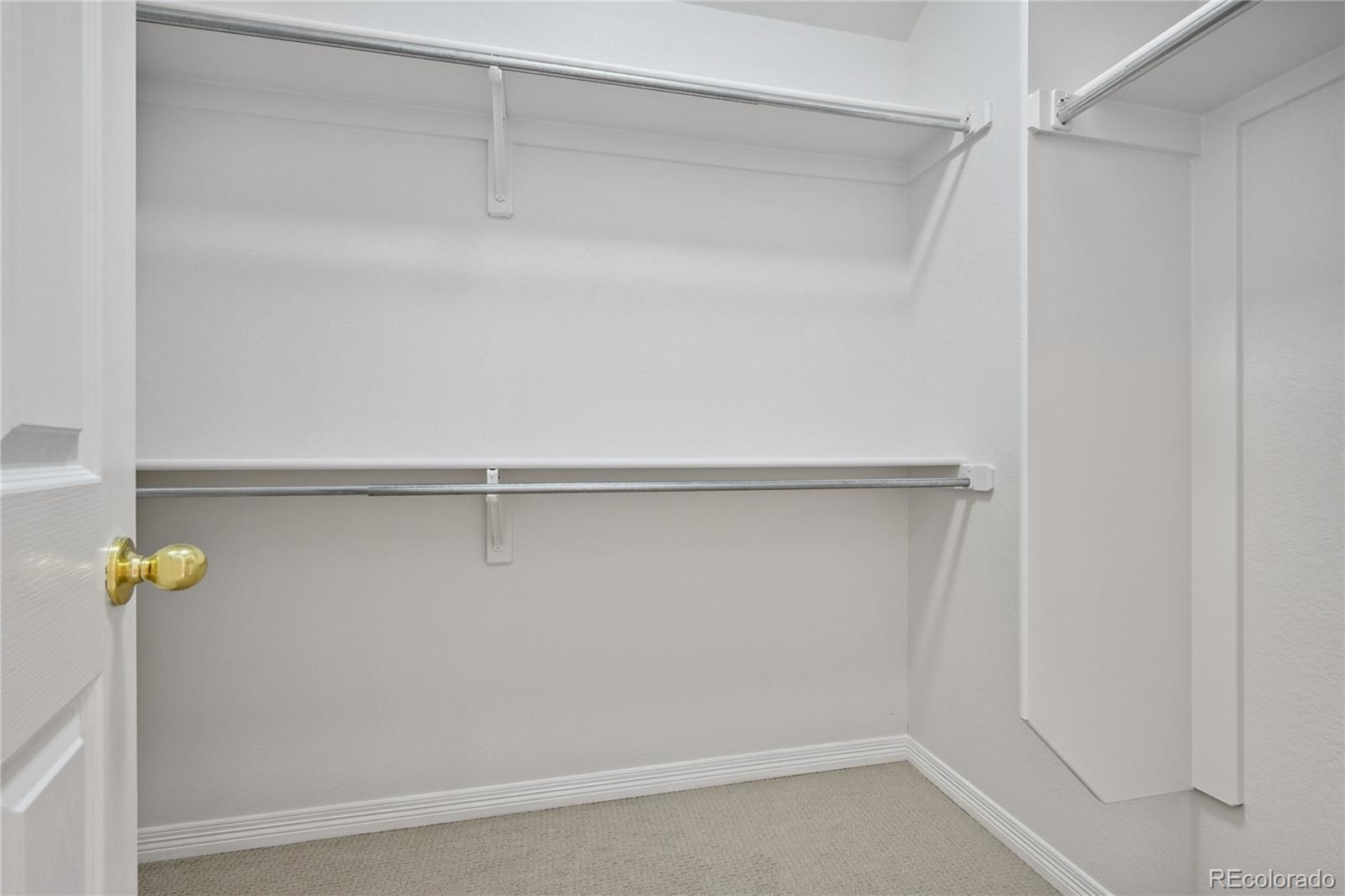 3515 Perry Street Denver, CO 80212 - Photo 20 of 40 a view of walk in closet with empty racks