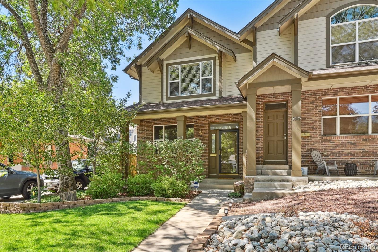 3515 Perry Street Denver, CO 80212 - Photo 29 of 40 a view of a brick house with a large windows and a yard