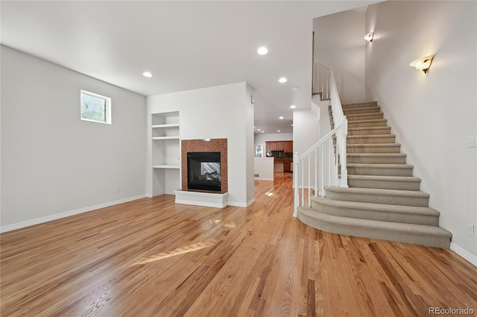 3515 Perry Street Denver, CO 80212 - Photo 4 of 40 a view of a livingroom with wooden floor and staircase