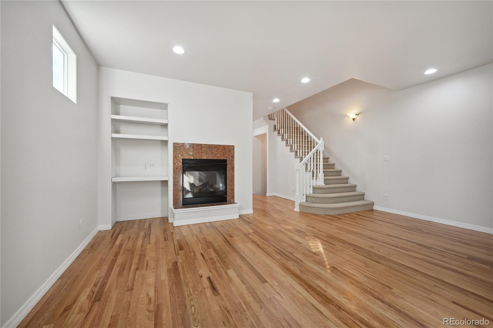 3515 Perry Street Denver, CO 80212 - Photo 5 of 40 a view of an empty room with wooden floor fireplace and a window