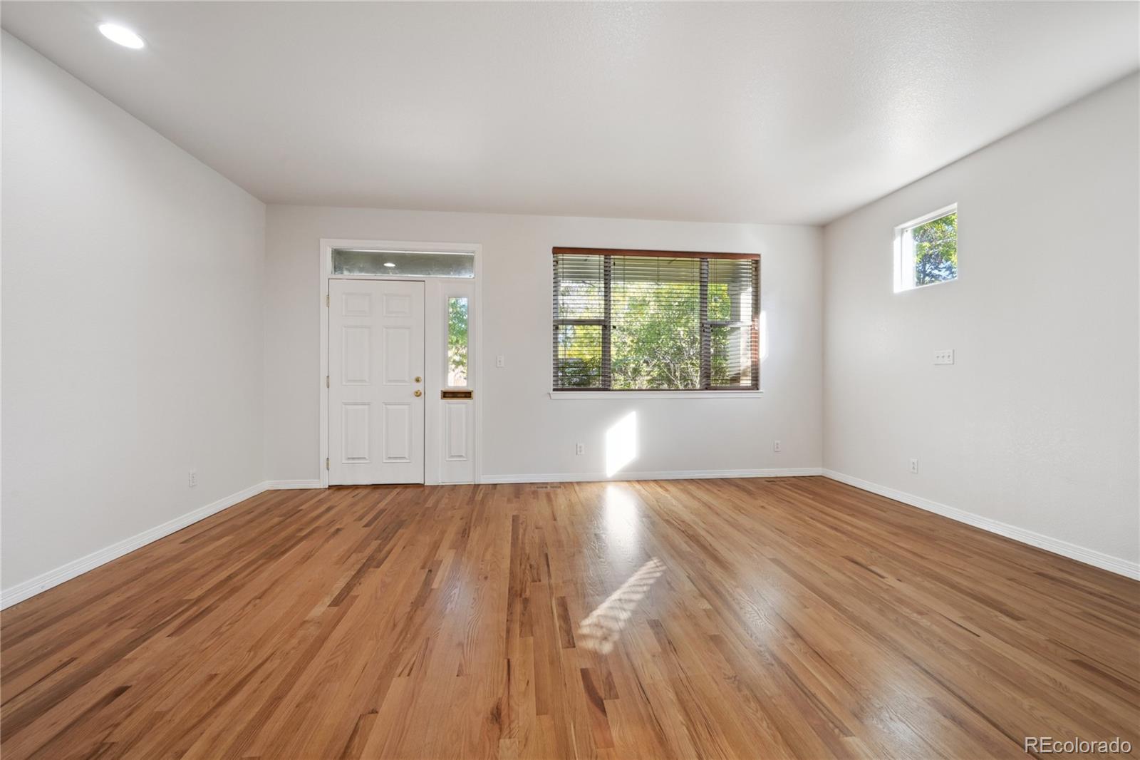 3515 Perry Street Denver, CO 80212 - Photo 7 of 40 an empty room with wooden floor and windows