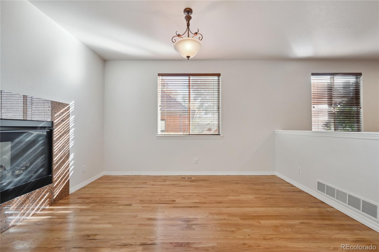 3515 Perry Street Denver, CO 80212 - Photo 9 of 40 a view of empty room with wooden floor and fan