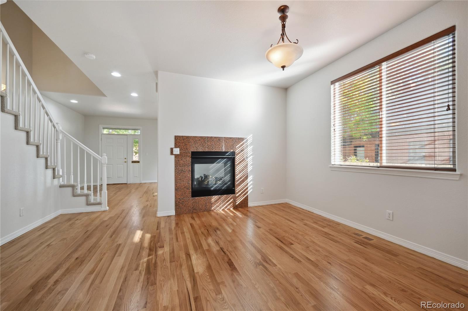 3515 Perry Street Denver, CO 80212 - Photo 10 of 40 a view of livingroom with wooden floor and fireplace