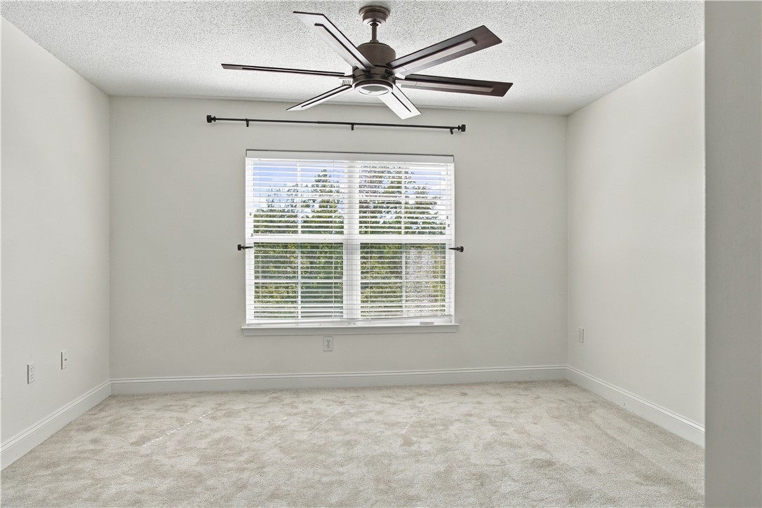 636 Lookover Drive Anderson, SC 29621 - Photo 25 of 34 A well-proportioned bedroom features soft carpeting and a wide window with integrated blinds.