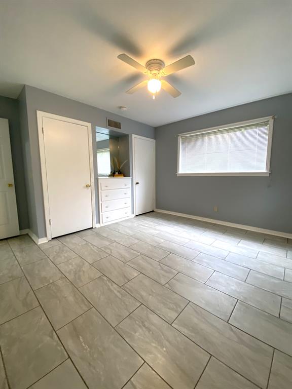 810 Poleman Road Shreveport, LA 71107 - Photo 18 of 25 a view of an empty room with window and chandelier fan