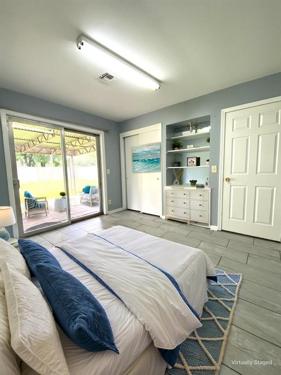 810 Poleman Road Shreveport, LA 71107 - Photo 6 of 25 a bedroom with a bed and wooden floor