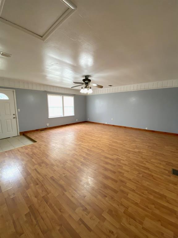 810 Poleman Road Shreveport, LA 71107 - Photo 7 of 25 an empty room with wooden floor and windows