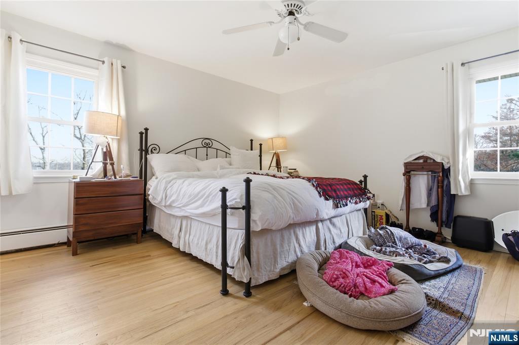 120 Carlough Road Upper Saddle River, NJ 07458 - Photo 16 of 25 a bedroom with a bed and a chandelier