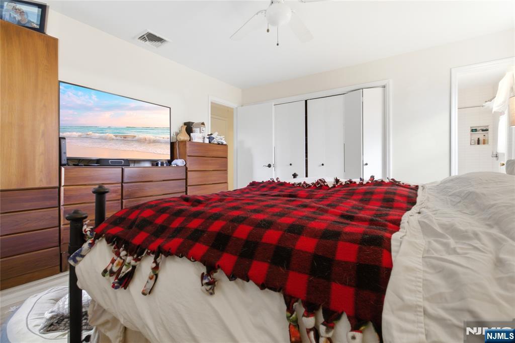 120 Carlough Road Upper Saddle River, NJ 07458 - Photo 17 of 25 a bedroom with a bed and a flat tv screen on the dresser
