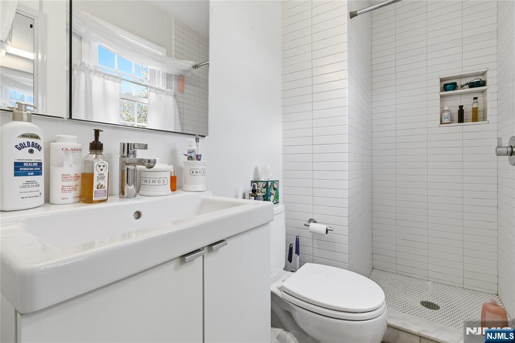 120 Carlough Road Upper Saddle River, NJ 07458 - Photo 20 of 25 a bathroom with a sink a toilet and shower