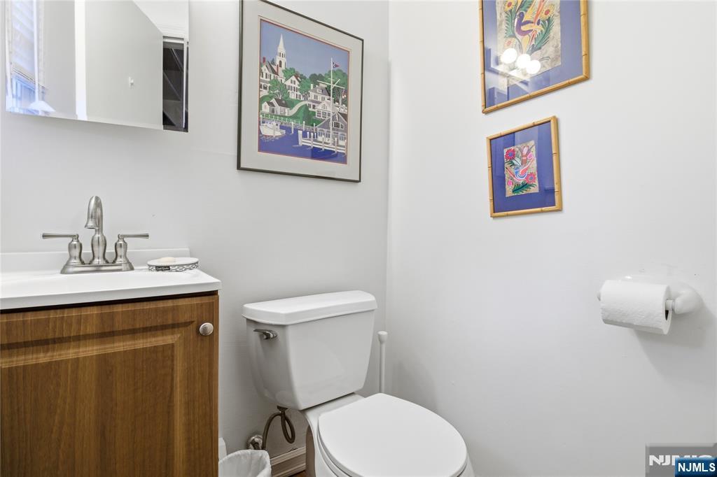 120 Carlough Road Upper Saddle River, NJ 07458 - Photo 21 of 25 a bathroom with a toilet sink and mirror