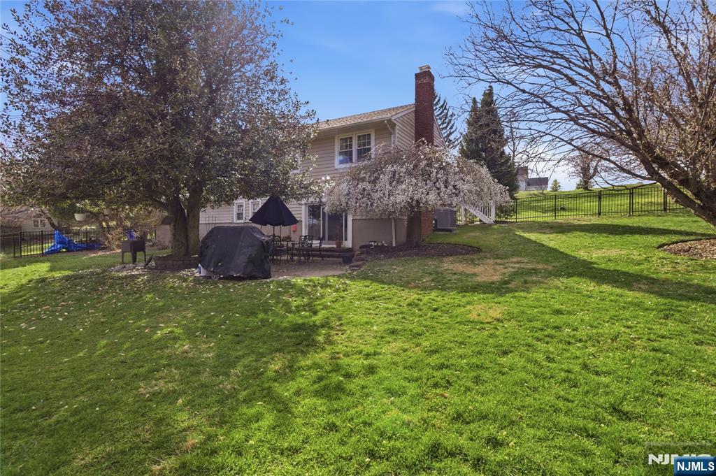 120 Carlough Road Upper Saddle River, NJ 07458 - Photo 23 of 25 a view of a house with a backyard