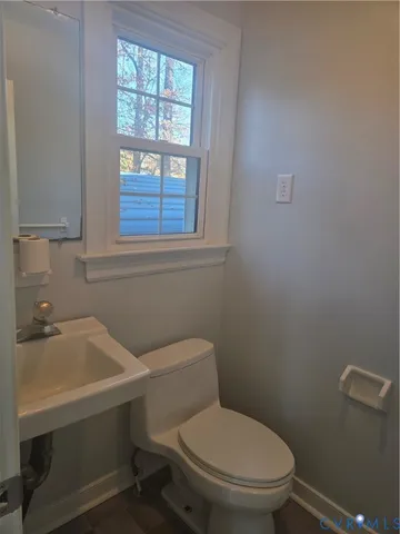 a bathroom with a sink a mirror and a toilet