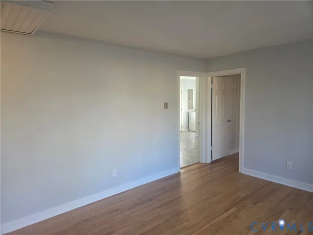 a view of a room with wooden floor